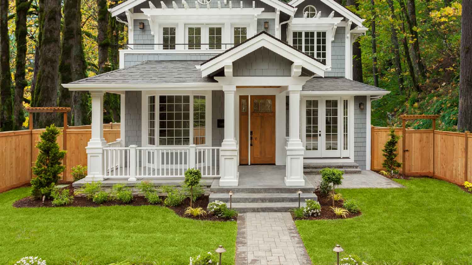A house surrounded by a forest with a woodland landscaping