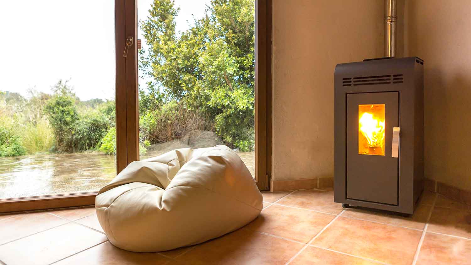Pellet stove with fire going installed by the patio door