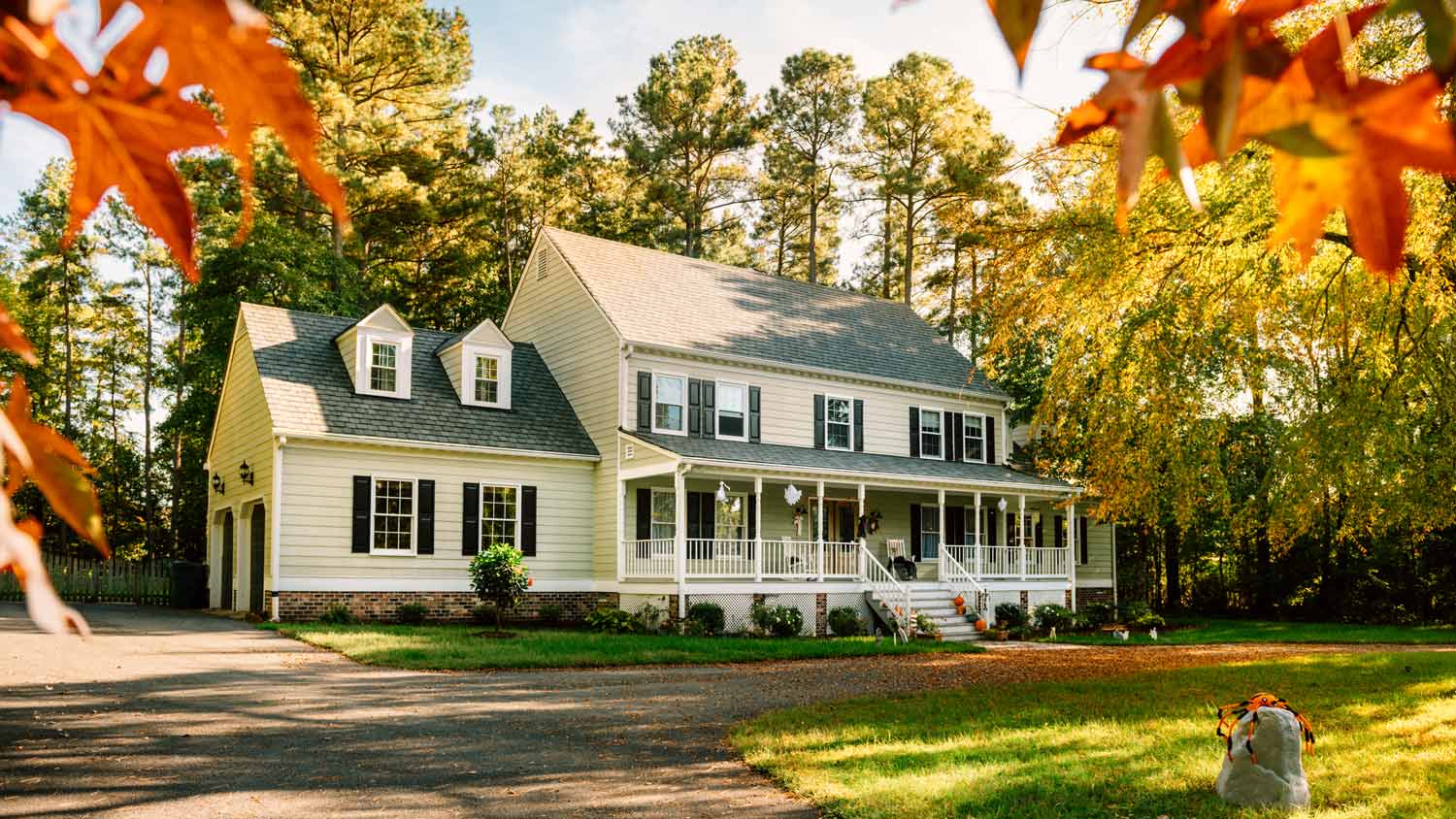 The exterior of a colonial house on an autumn day