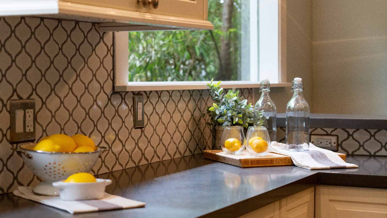 A kitchen with a gray laminate countertop