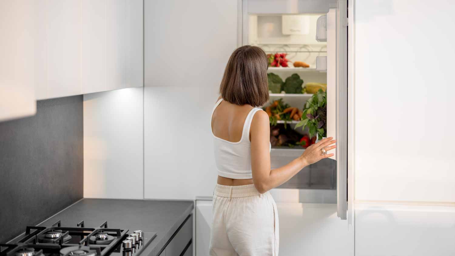 Woman standing near the fridge