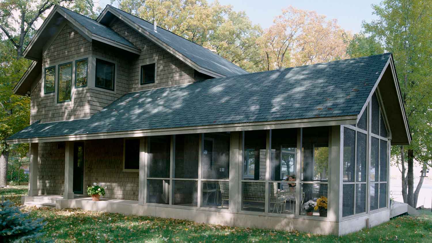 A cozy house with architectural shingles on its roof