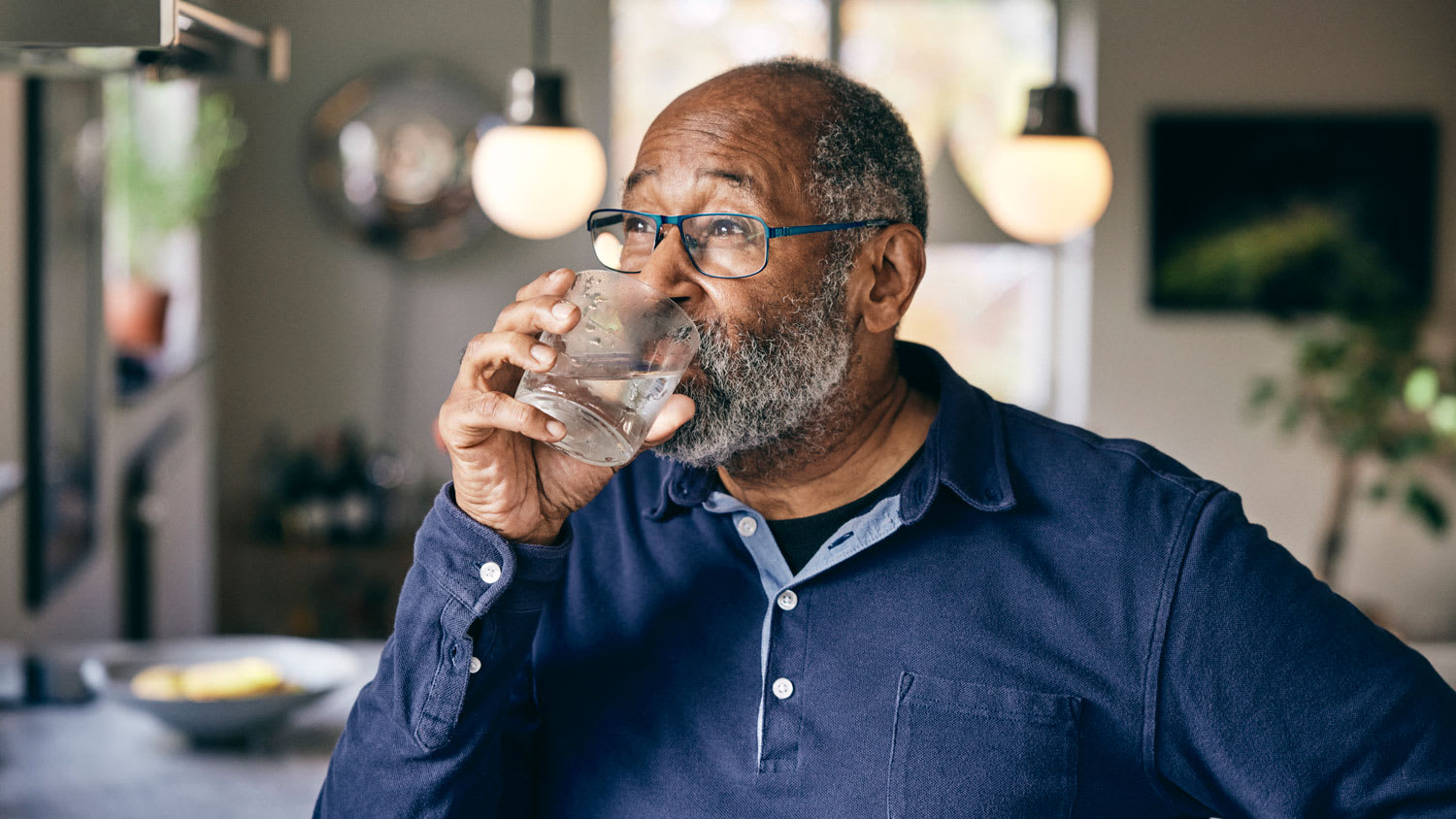 Older man drinking a glass of water
