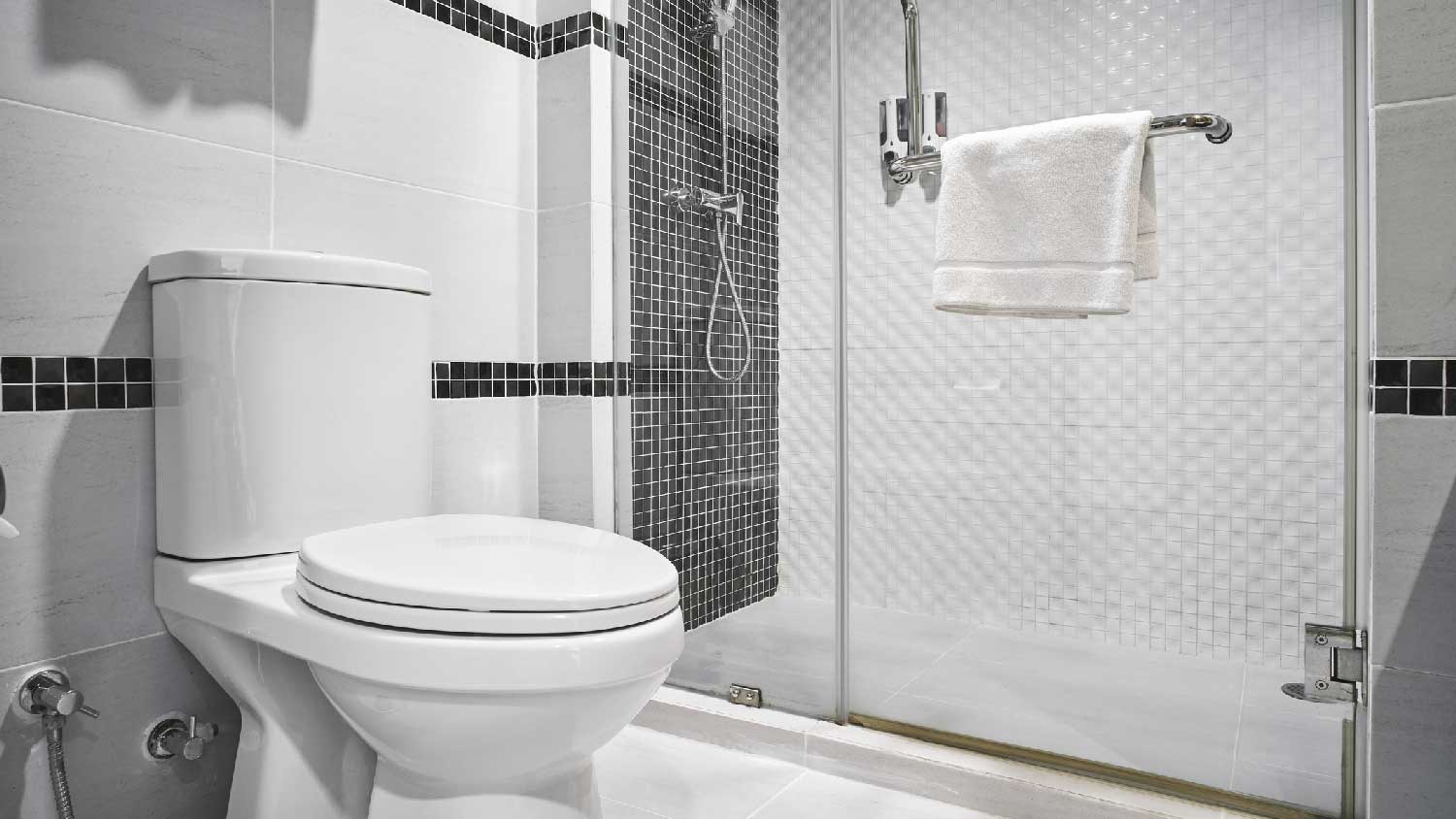 A toilet in a white bathroom