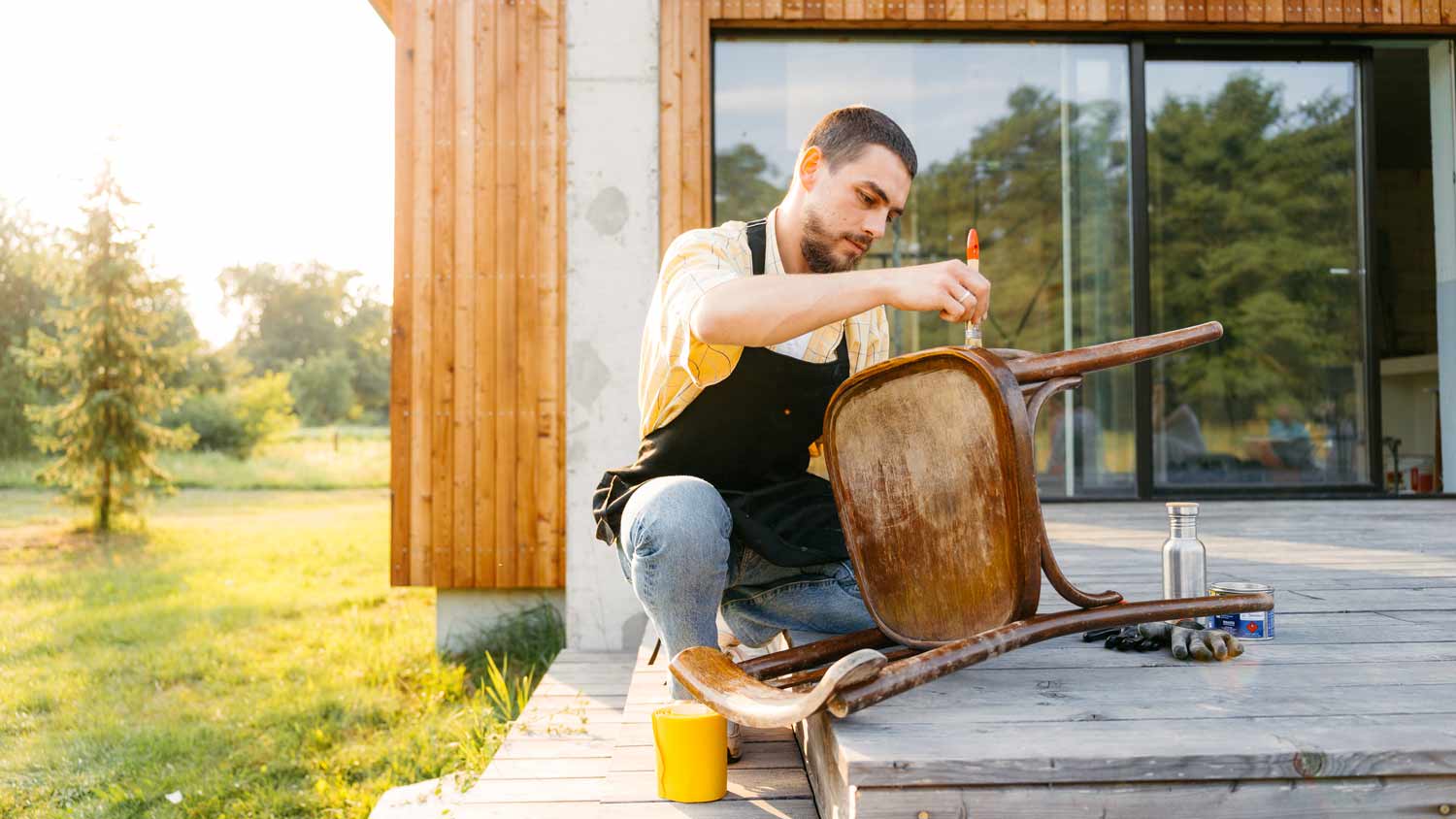 man on deck staining chair