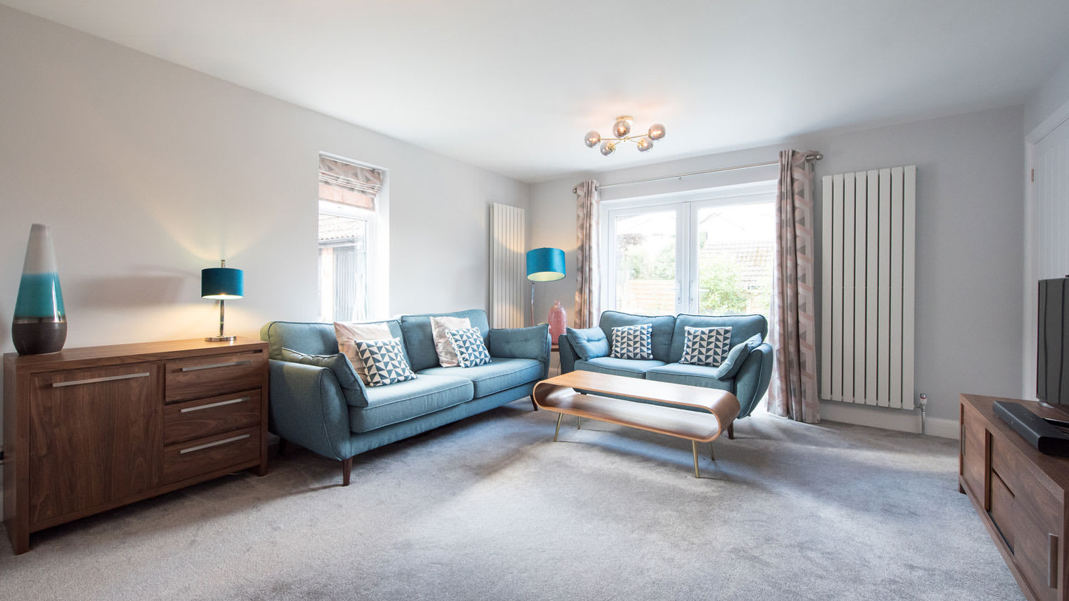 A retro living room with a wall-to-wall carpet