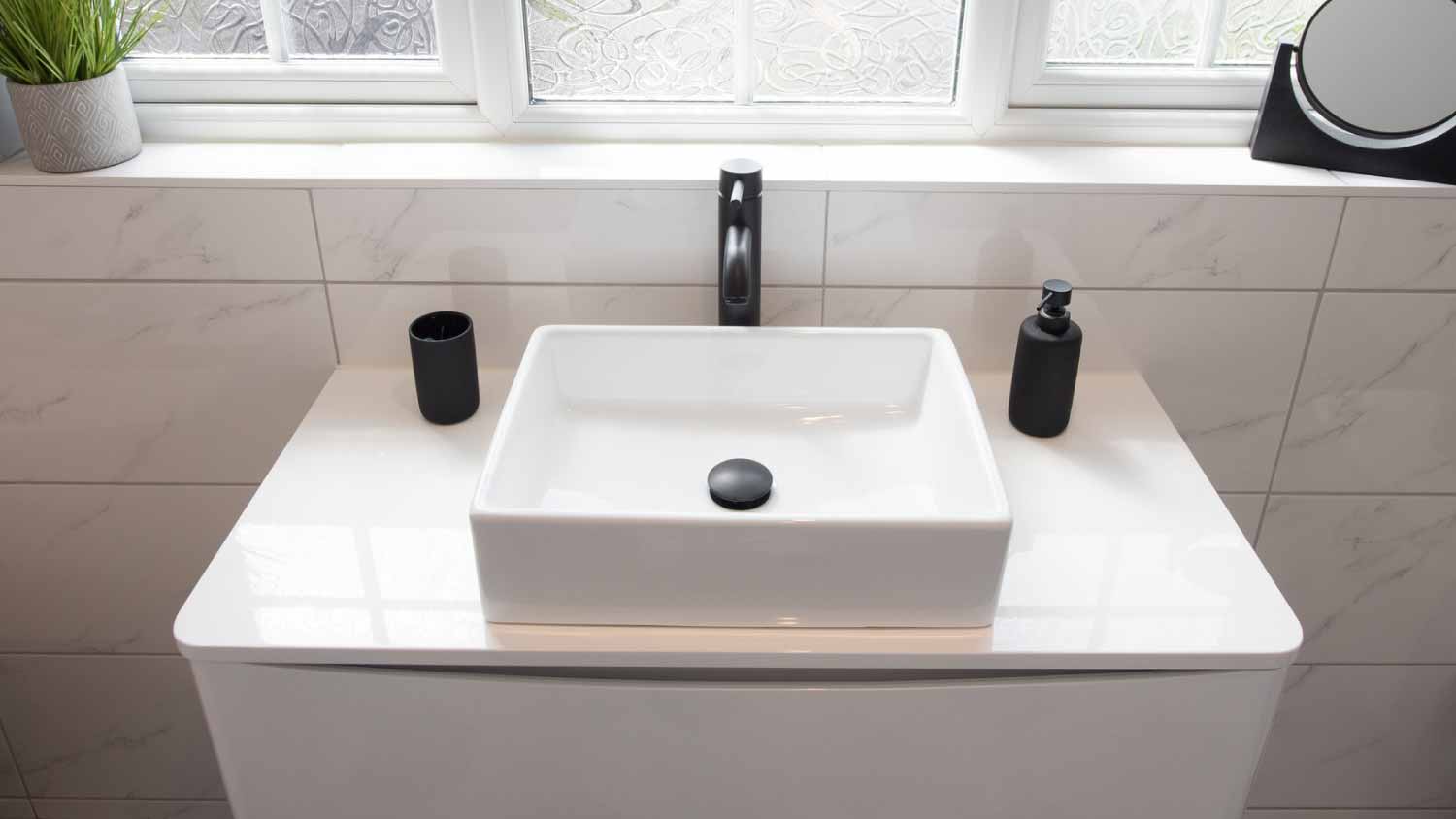 Basin with matt black tap and accessories