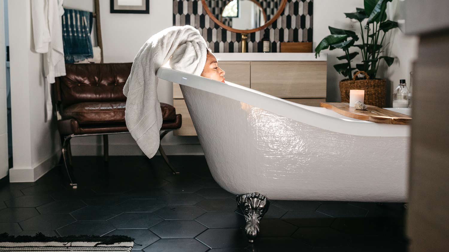 woman taking a bath in claw foot tub