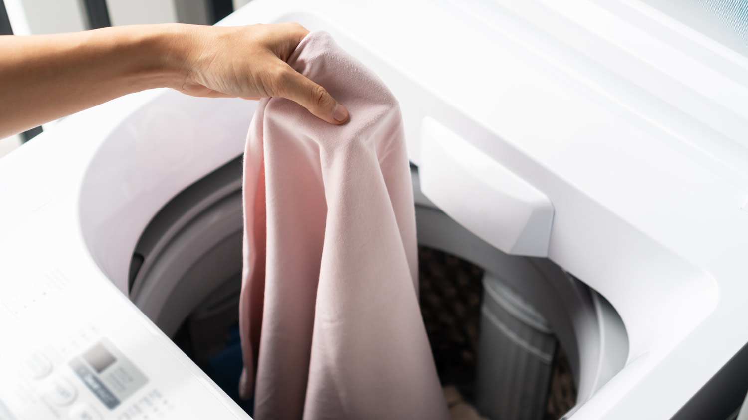adding clothes to top load dryer