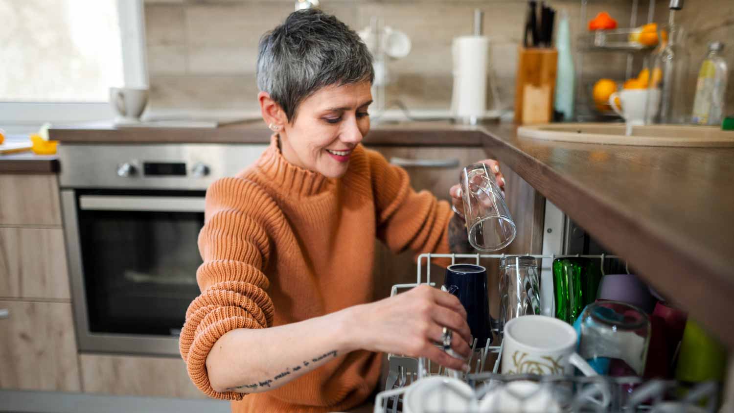 Woman putting dishes in dishwasher