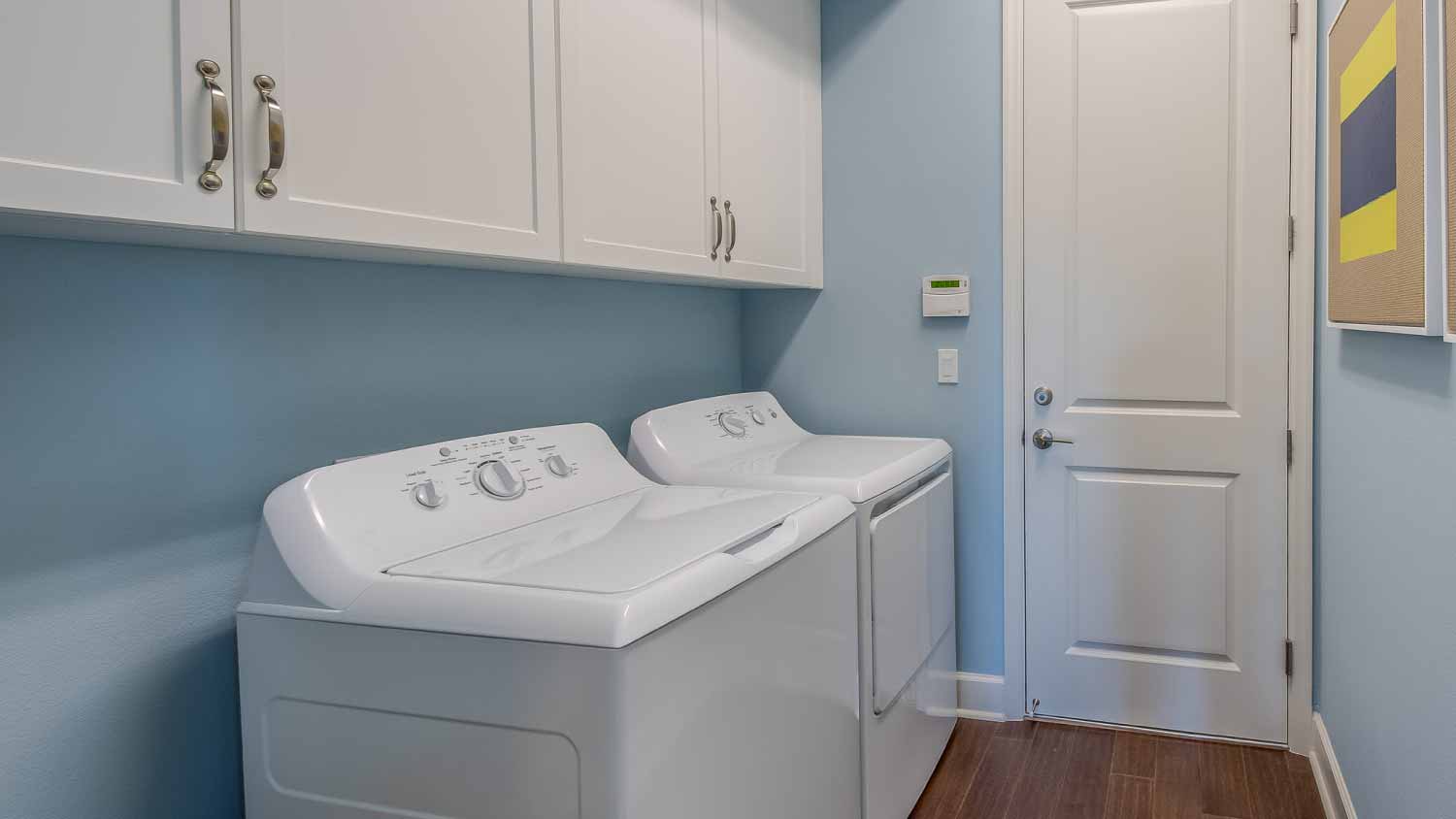 Laundry room with light blue painted walls