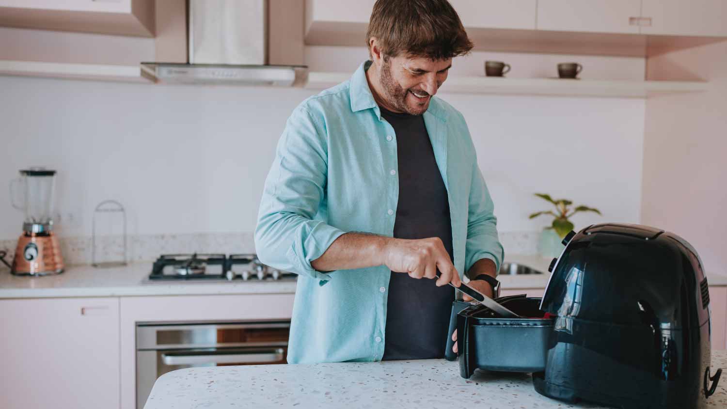 Man preparing food in the air fryer