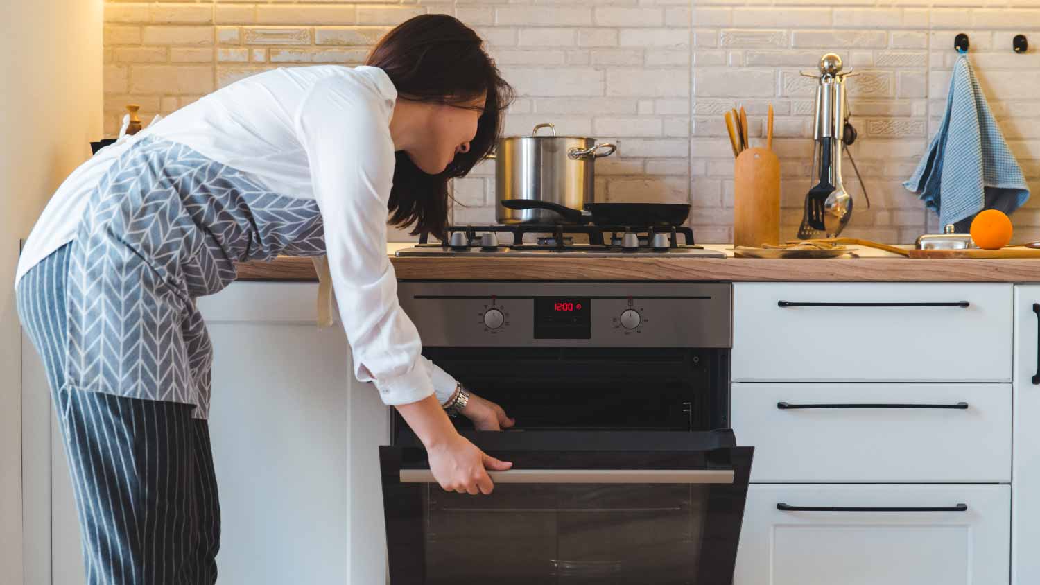 Woman opening an oven