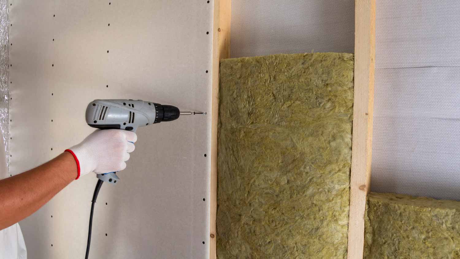Worker installing a drywall