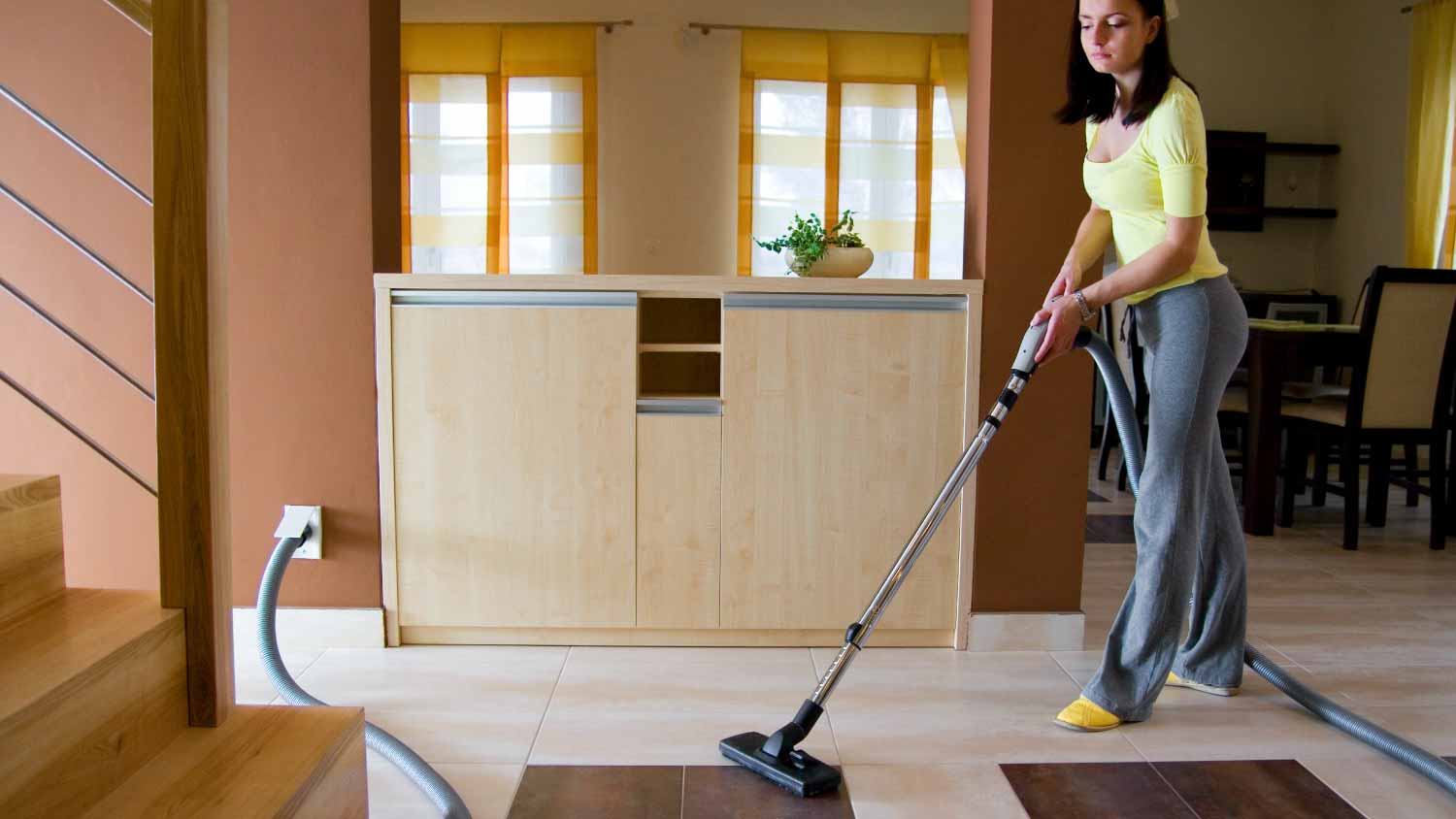 Young woman cleaning floor
