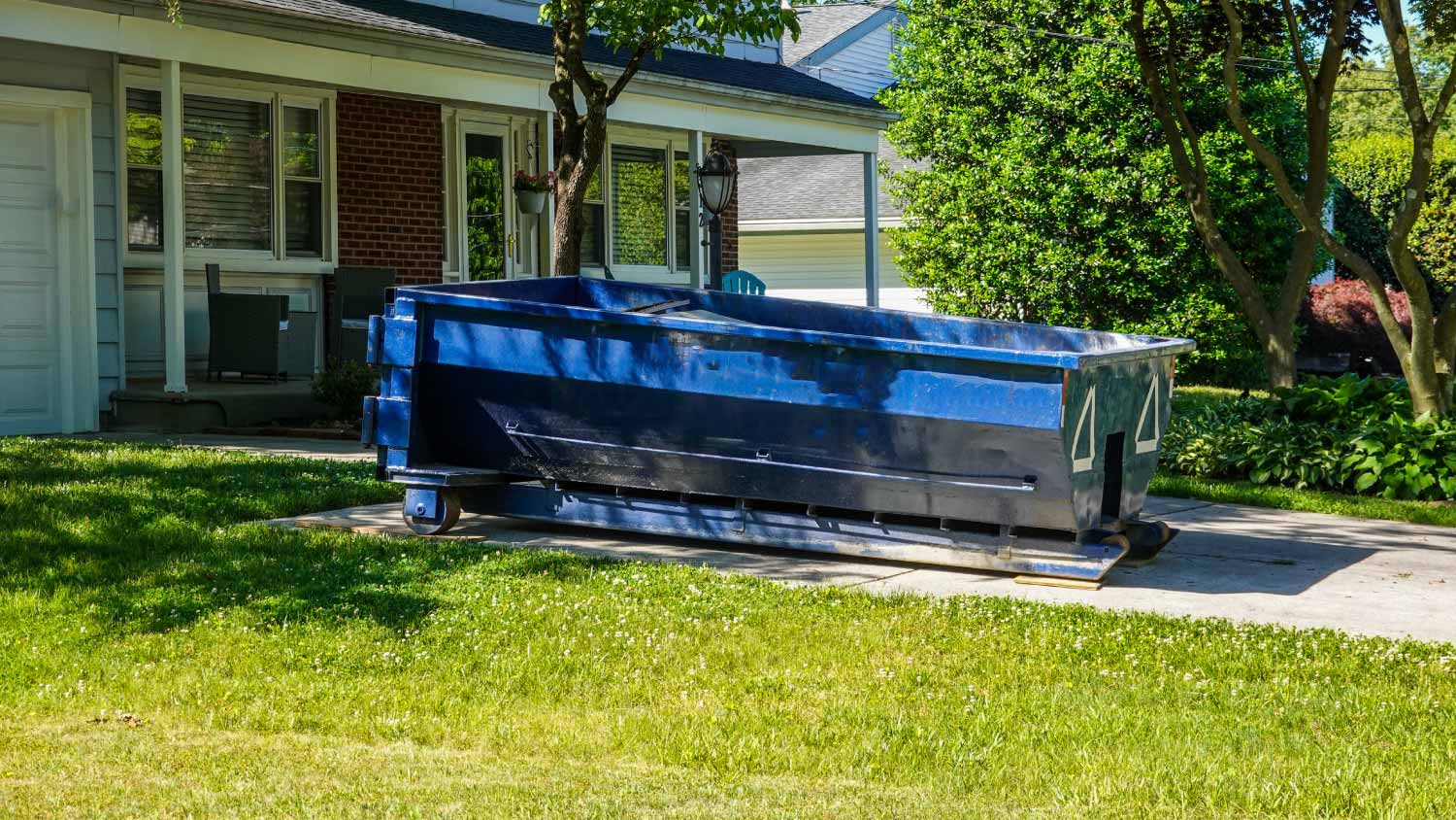 Blue dumpster in the driveway
