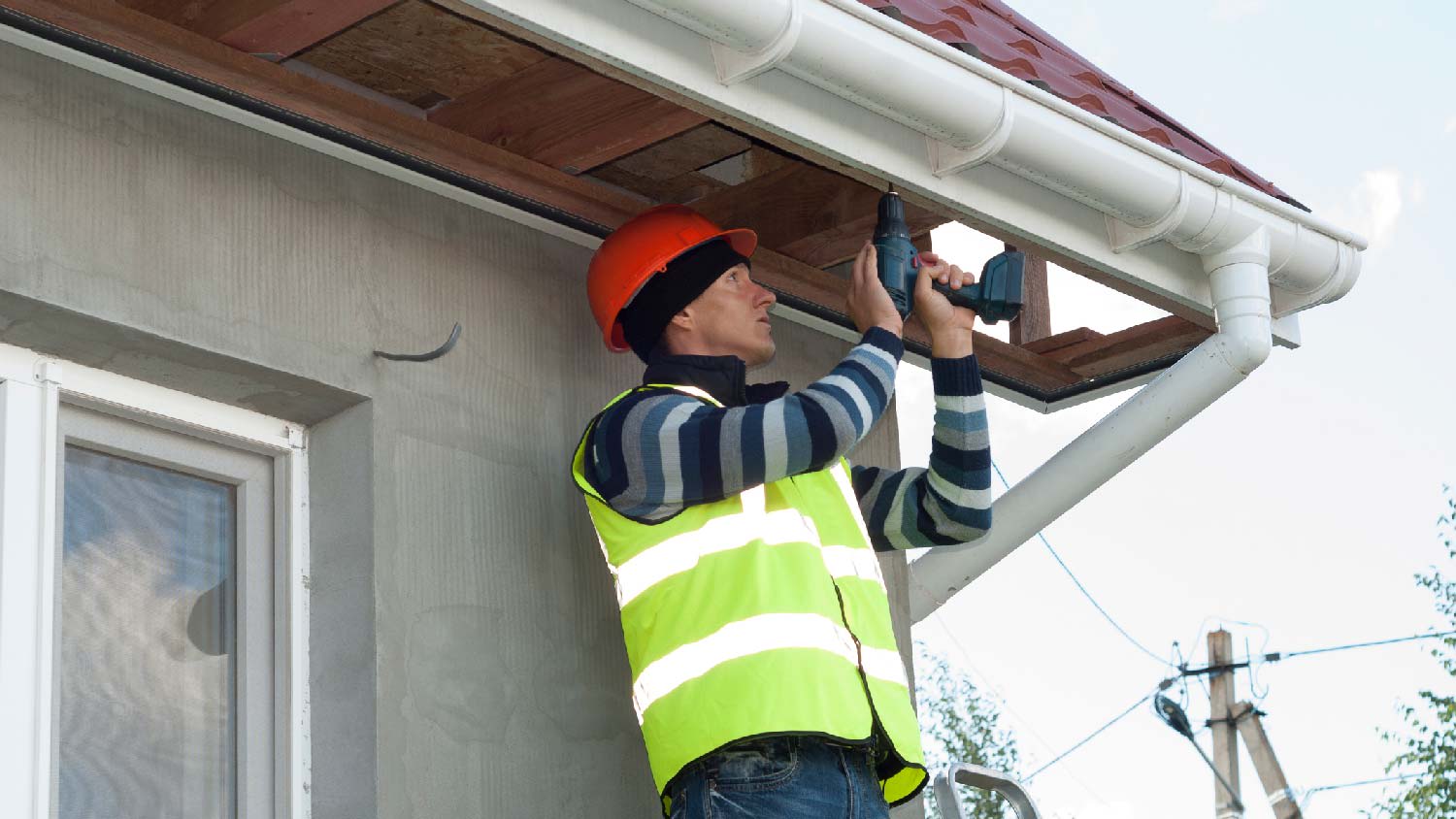 A professional installing a soffit