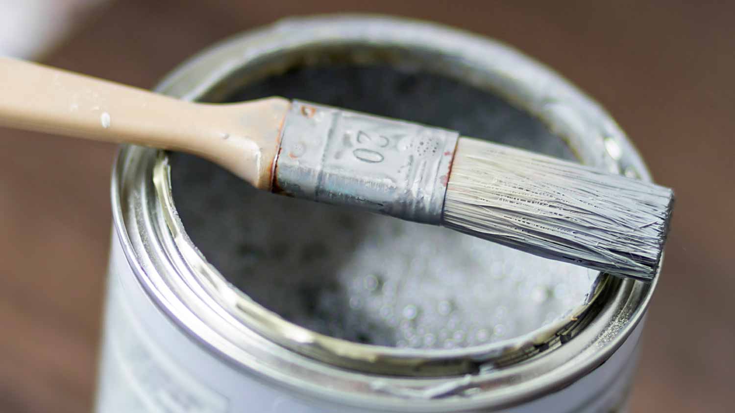 Paint brush laying on can