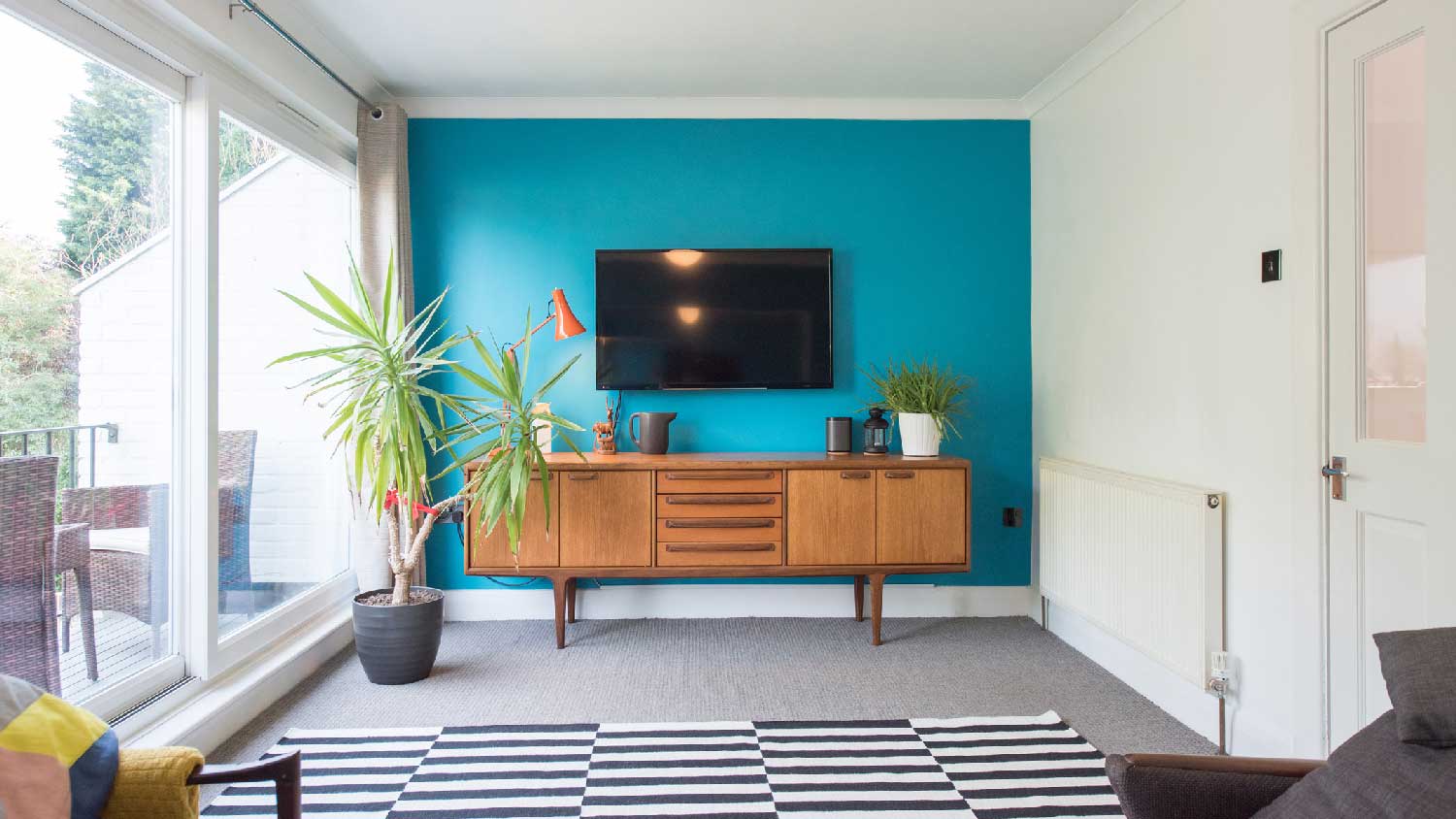 A carpeted living room with a rug