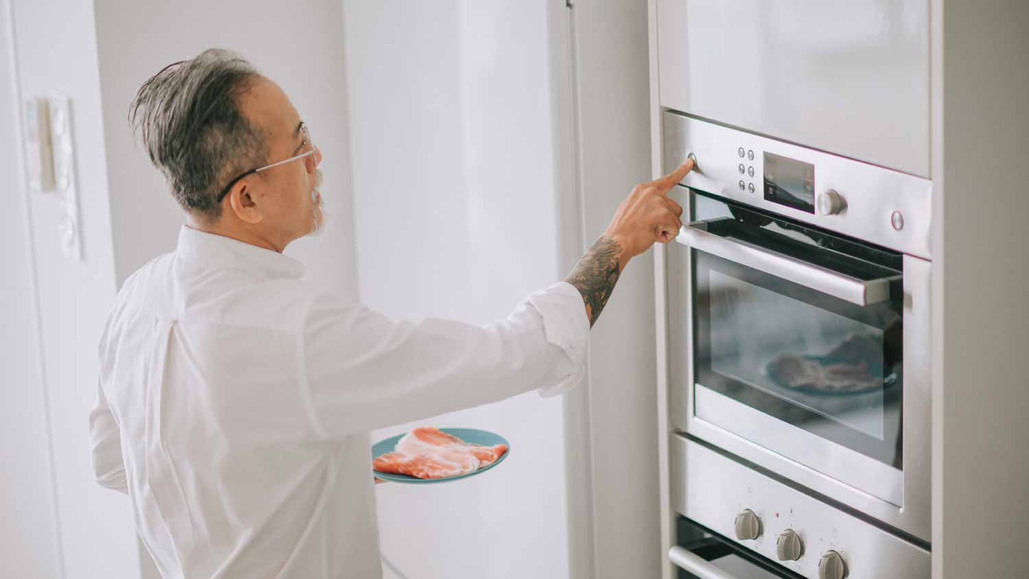 Man turning on microwave