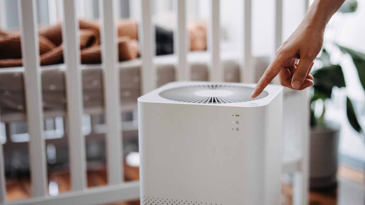 Woman turning on home air purifier
