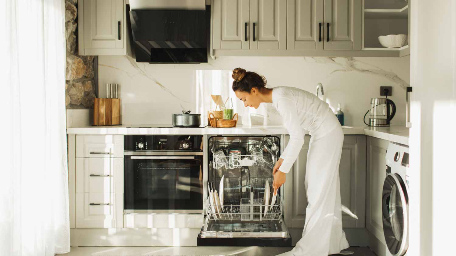 Woman putting dishes in dishwasher