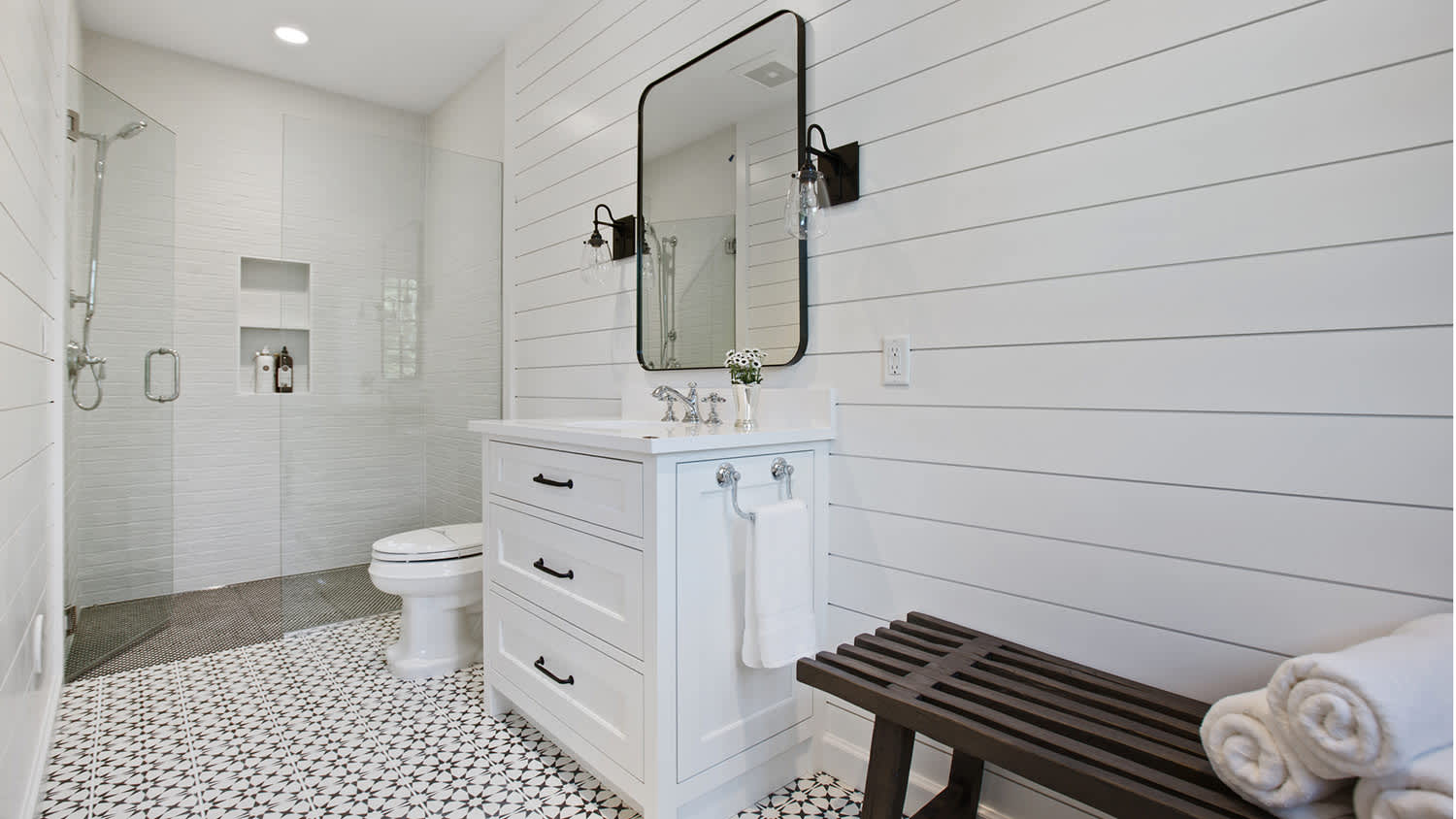Black mirror in white bathroom