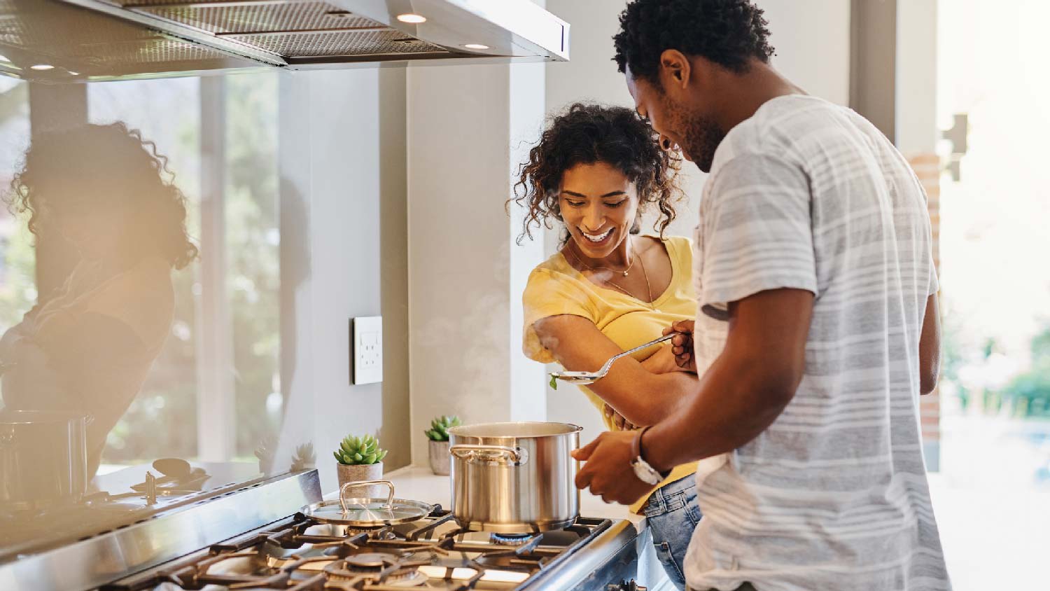 A couple cooking on a freestanding range
