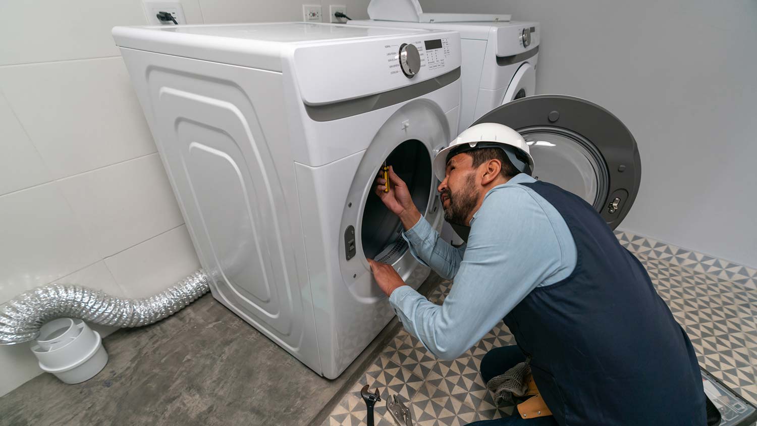 A handyman replacing a dryer belt