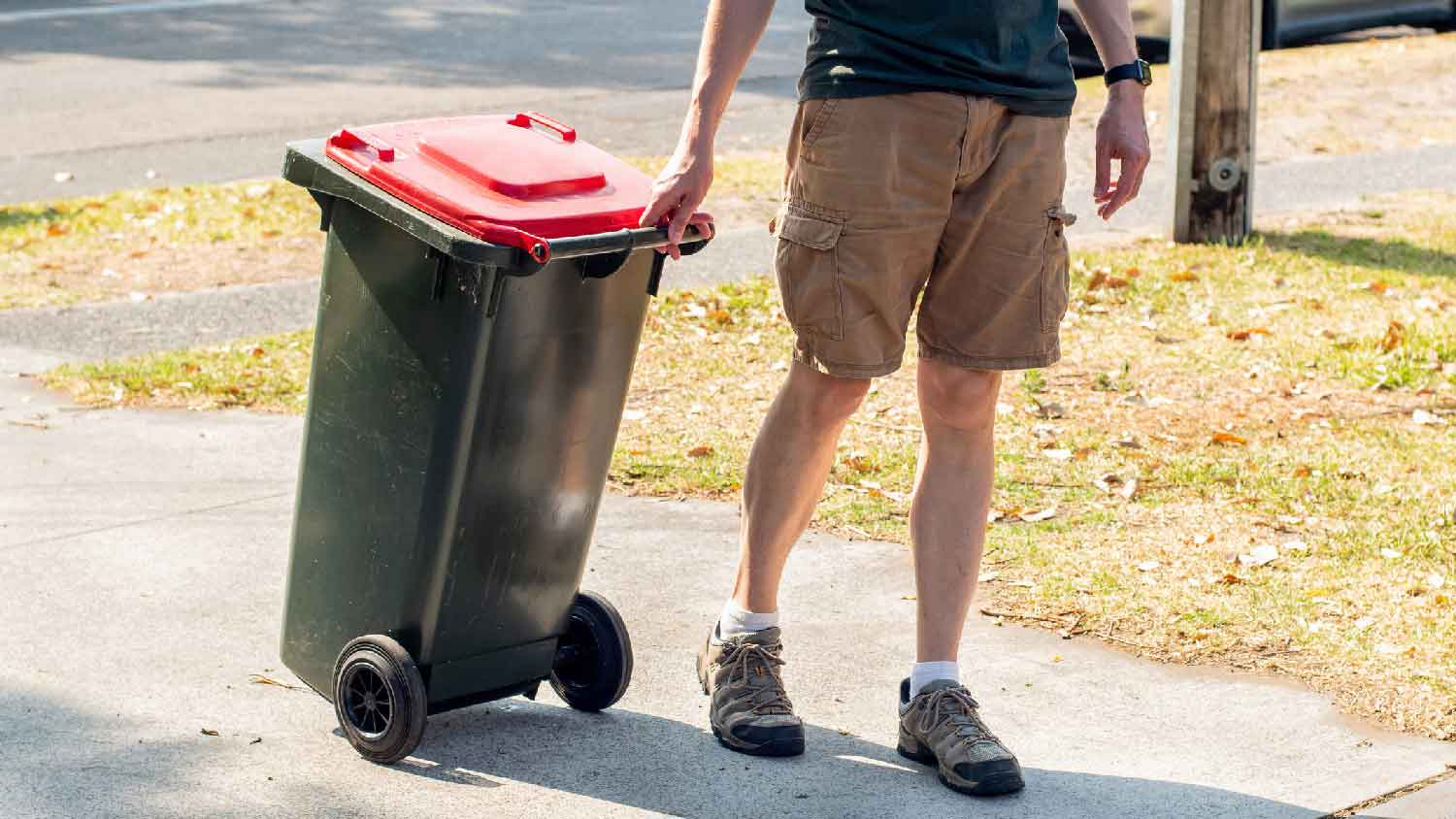 A man taking out a garbage bin