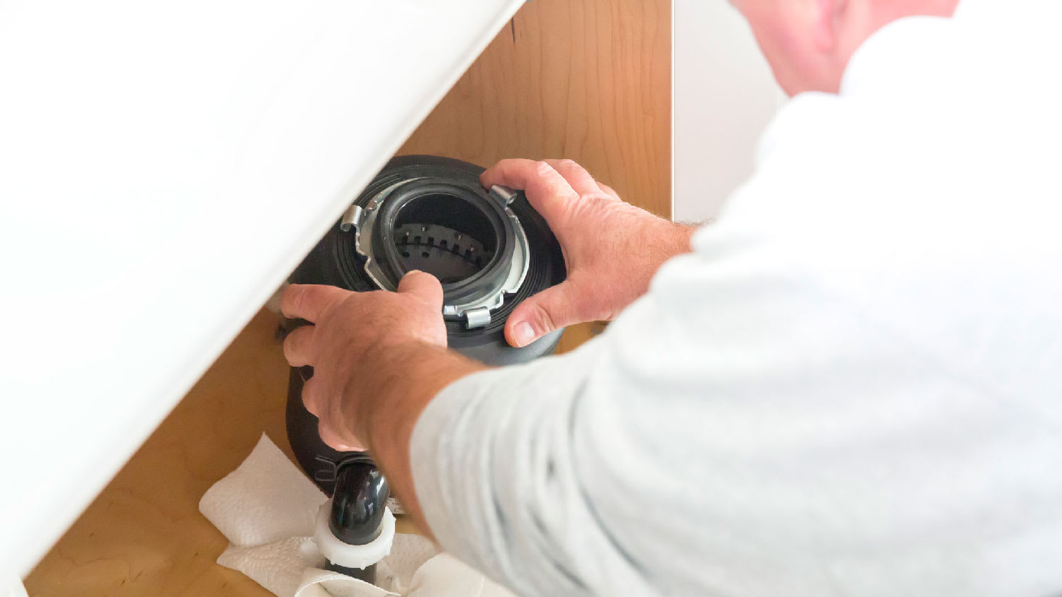 A professional repairing garbage disposal