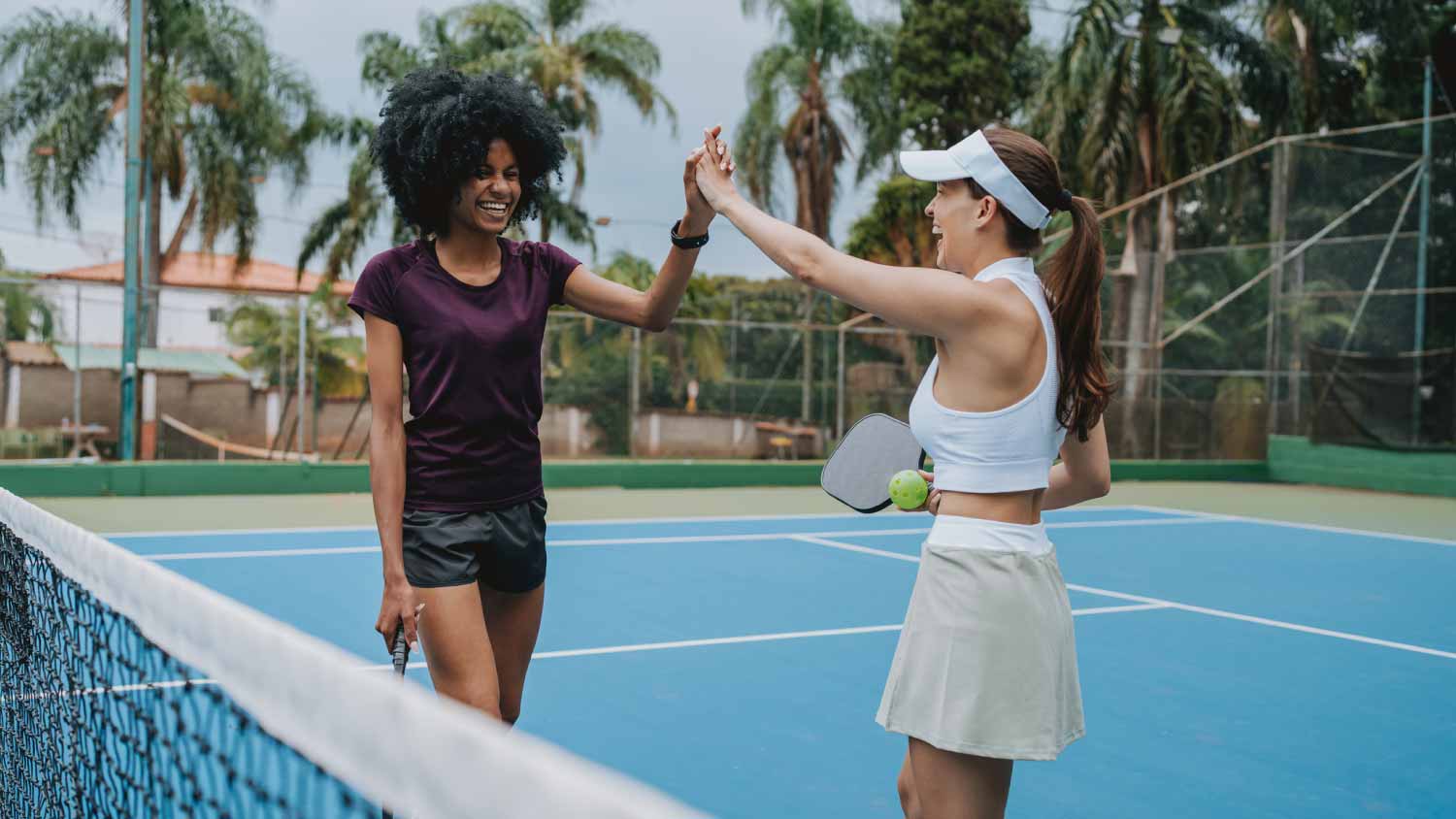Women celebrating pickleball point