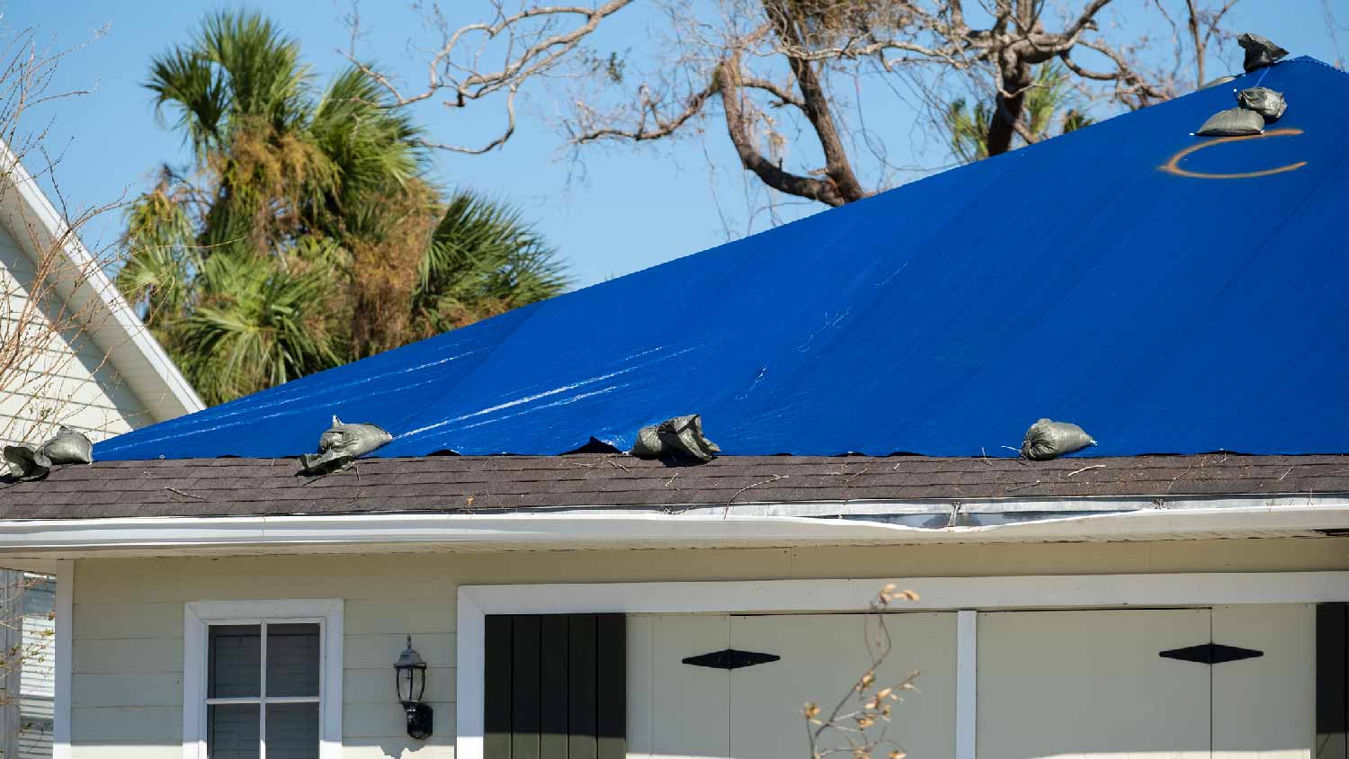 A house with a tarped roof