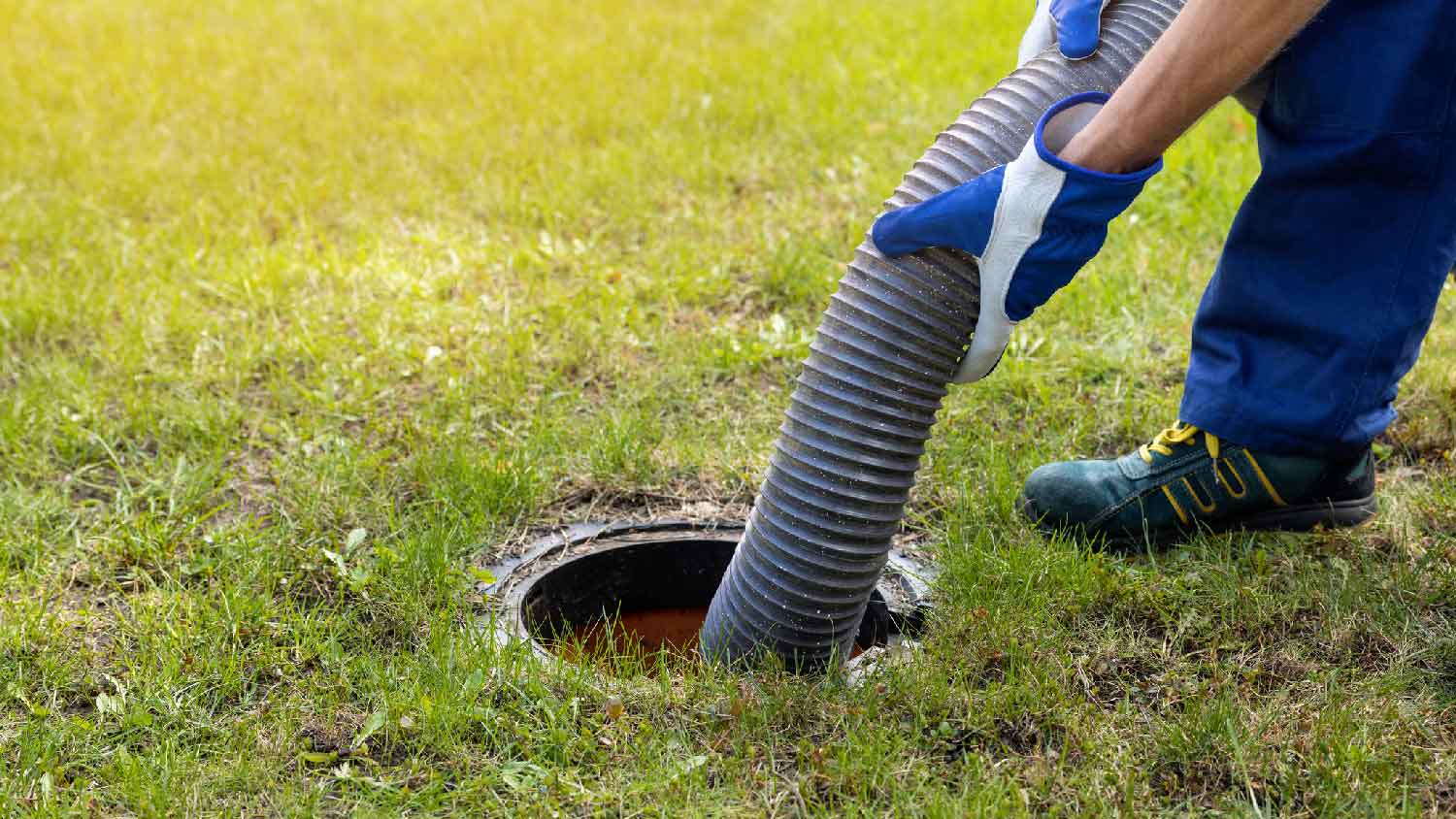 A professional emptying a septic tank