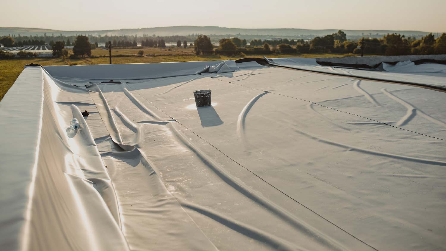 The installation of a TPO roof at sunset