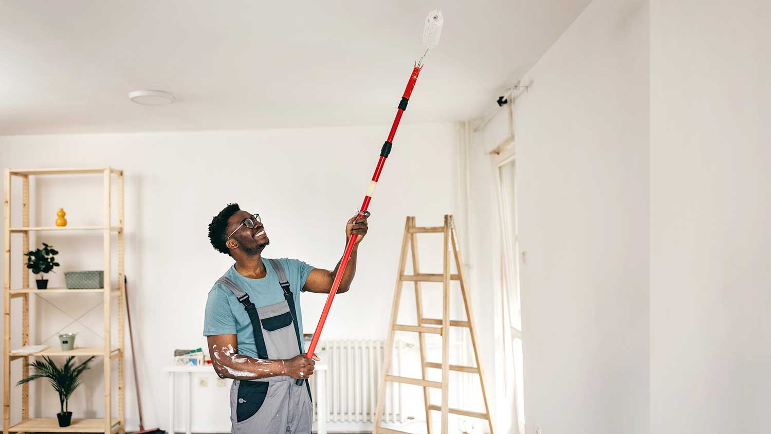 Young man repairing ceiling of the apartment