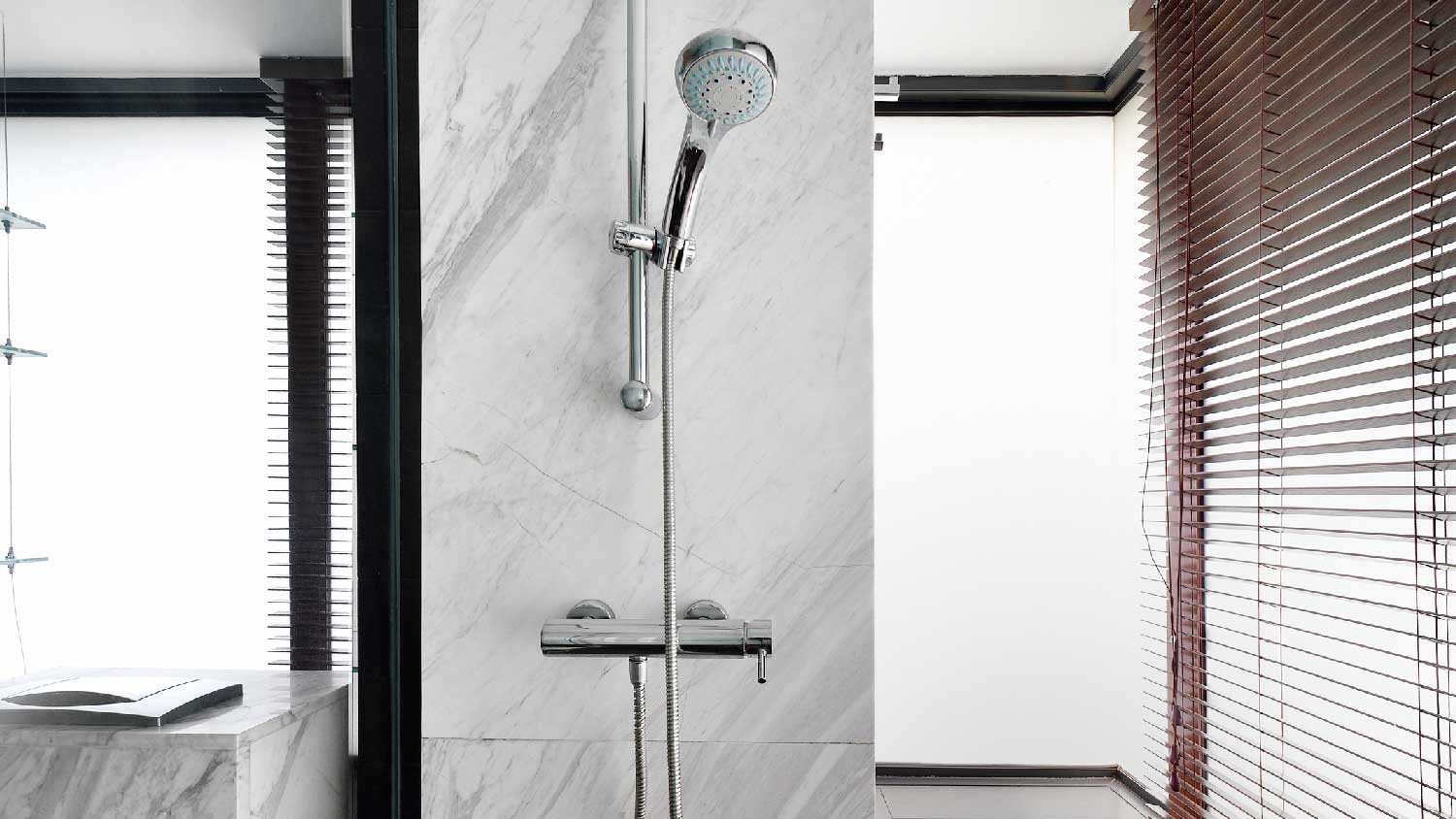 A marble shower stall in a bathroom