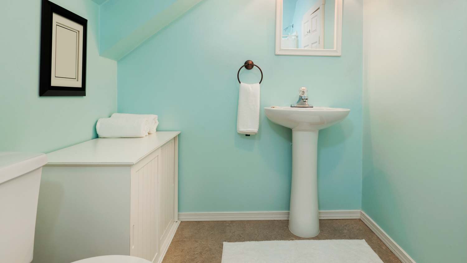 Small colorful bathroom with an oval sink.