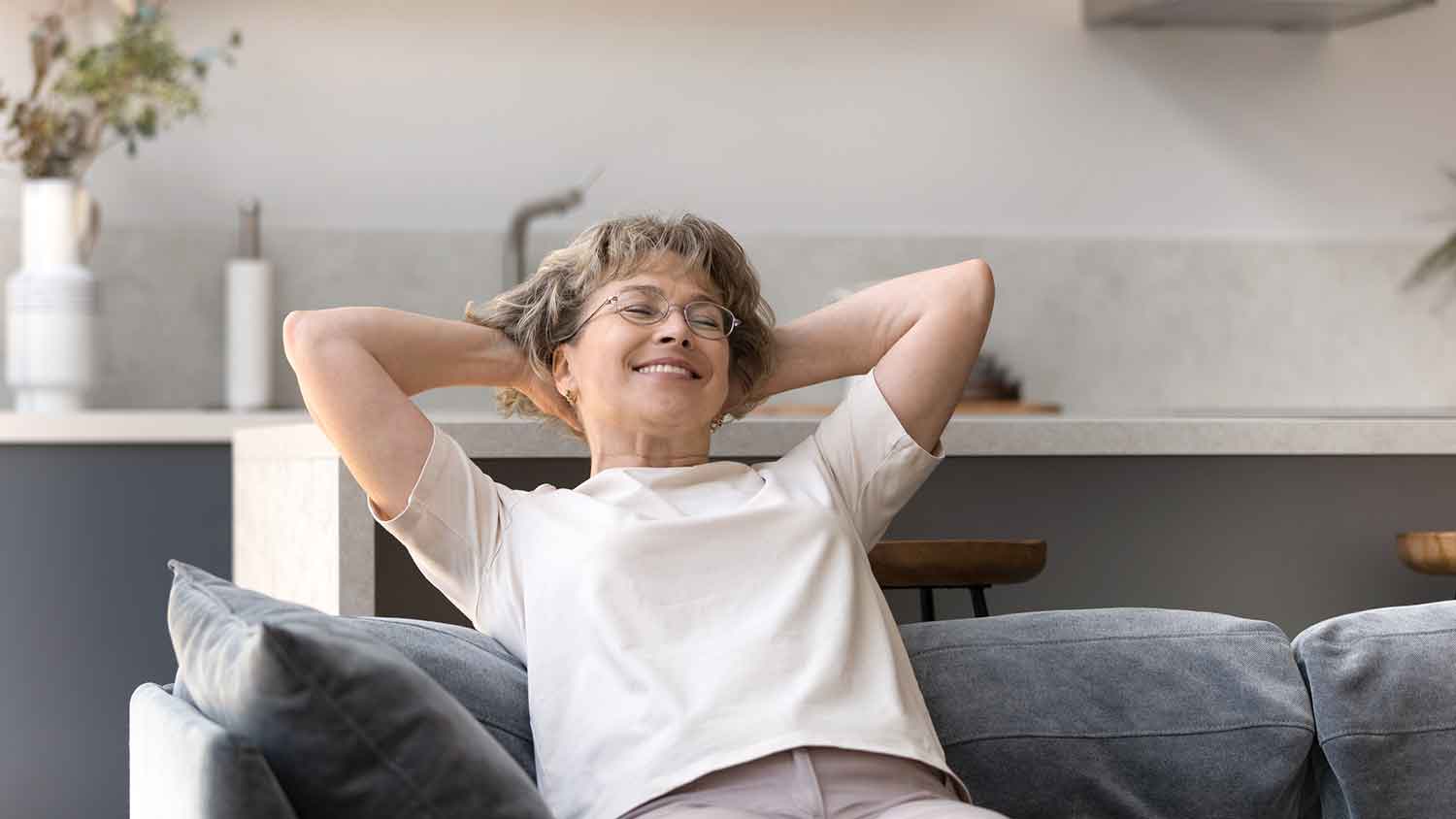Woman sitting on the couch relaxing and smiling