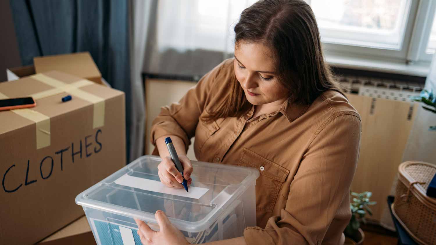 Woman labeling plastic container