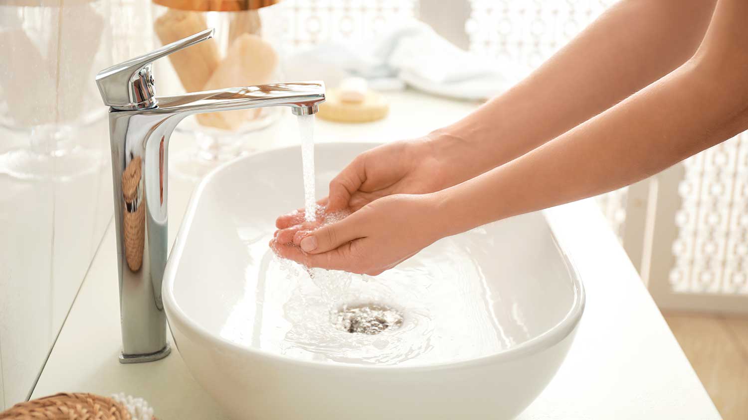 Woman washing hands in the bathroom