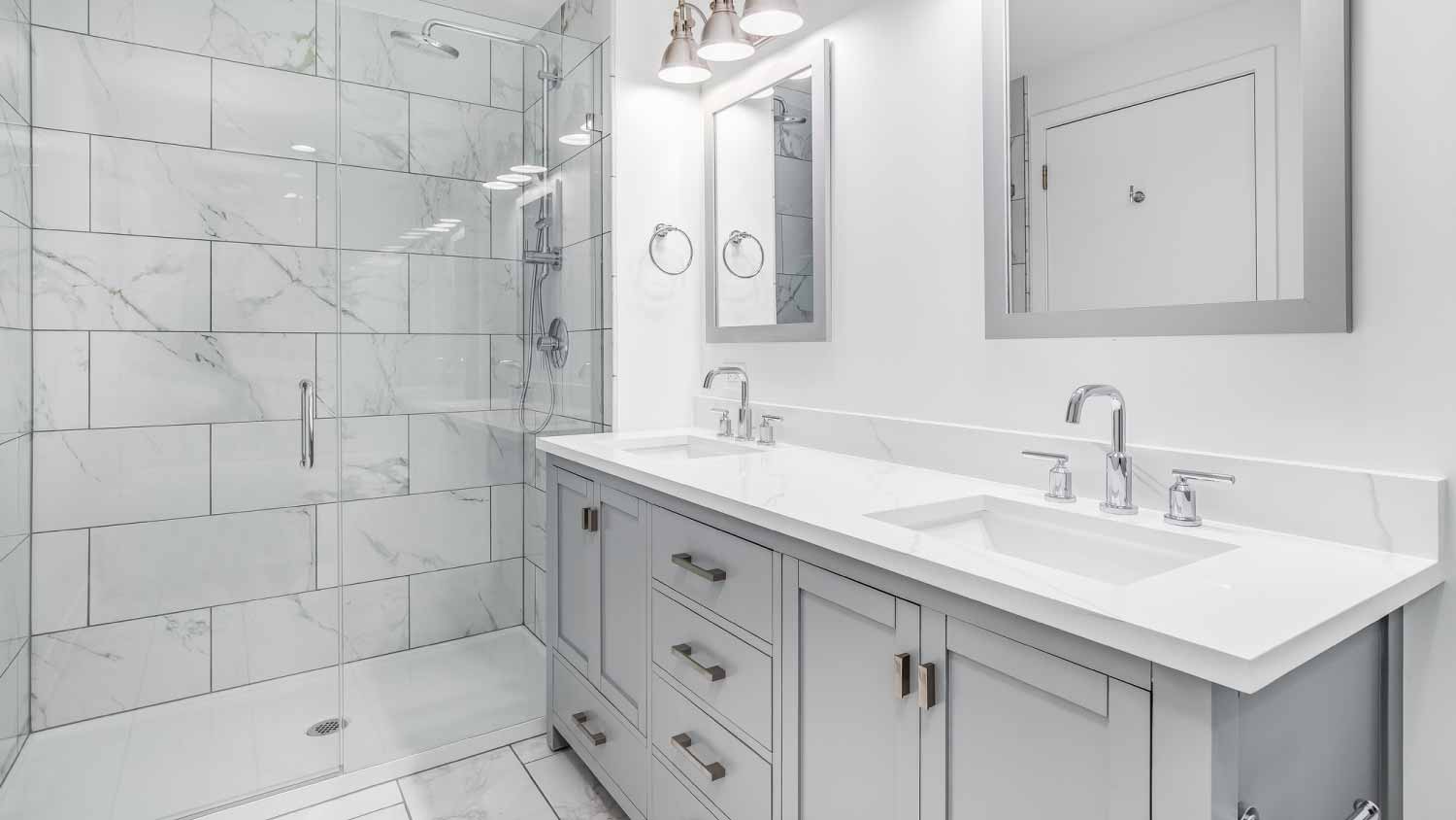 Bathroom with a gray cabinet and tiled shower
