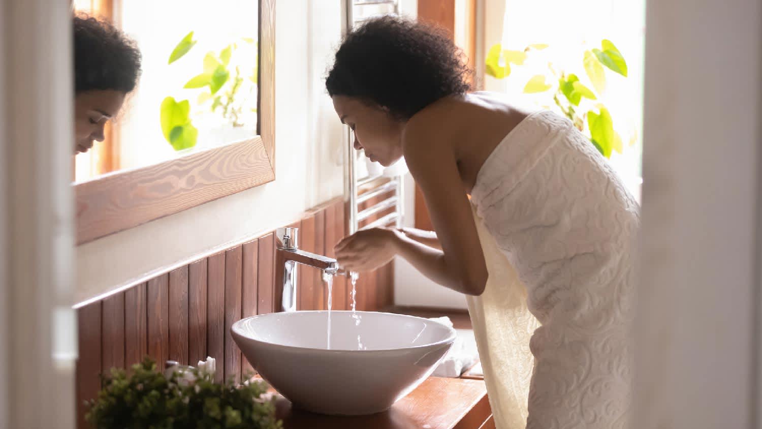 A woman washing her face in the bathroom