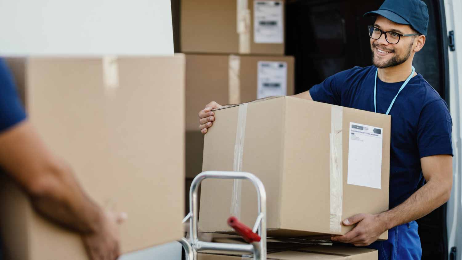 Worker unloading cardboard boxes