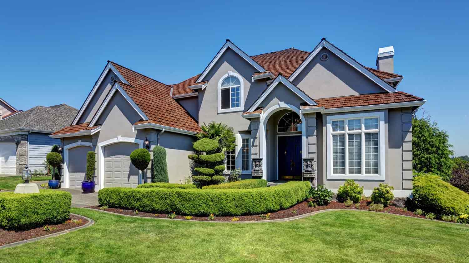 luxury home with brown roof
