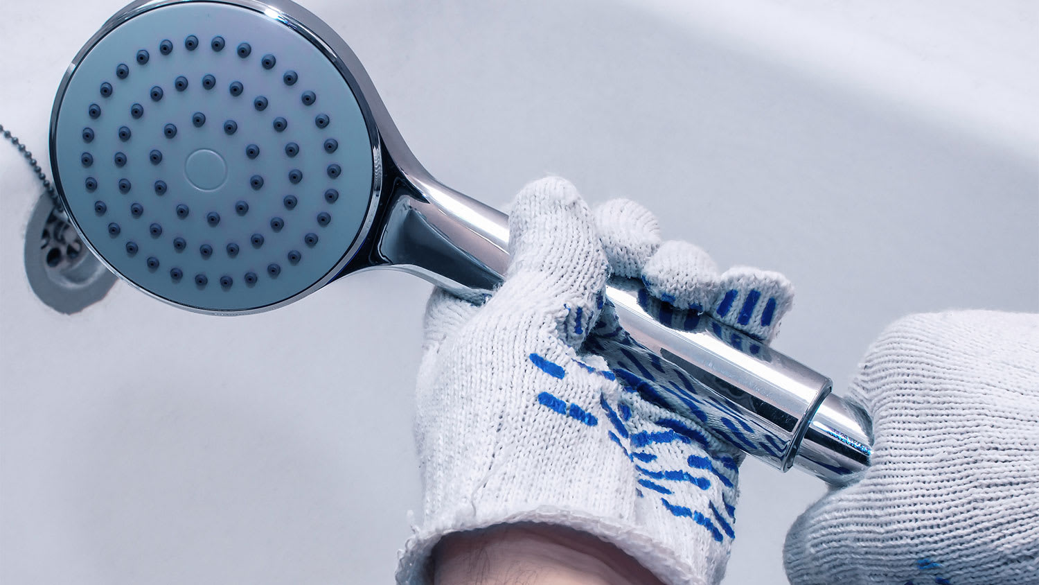 A view of someone removing a showerhead