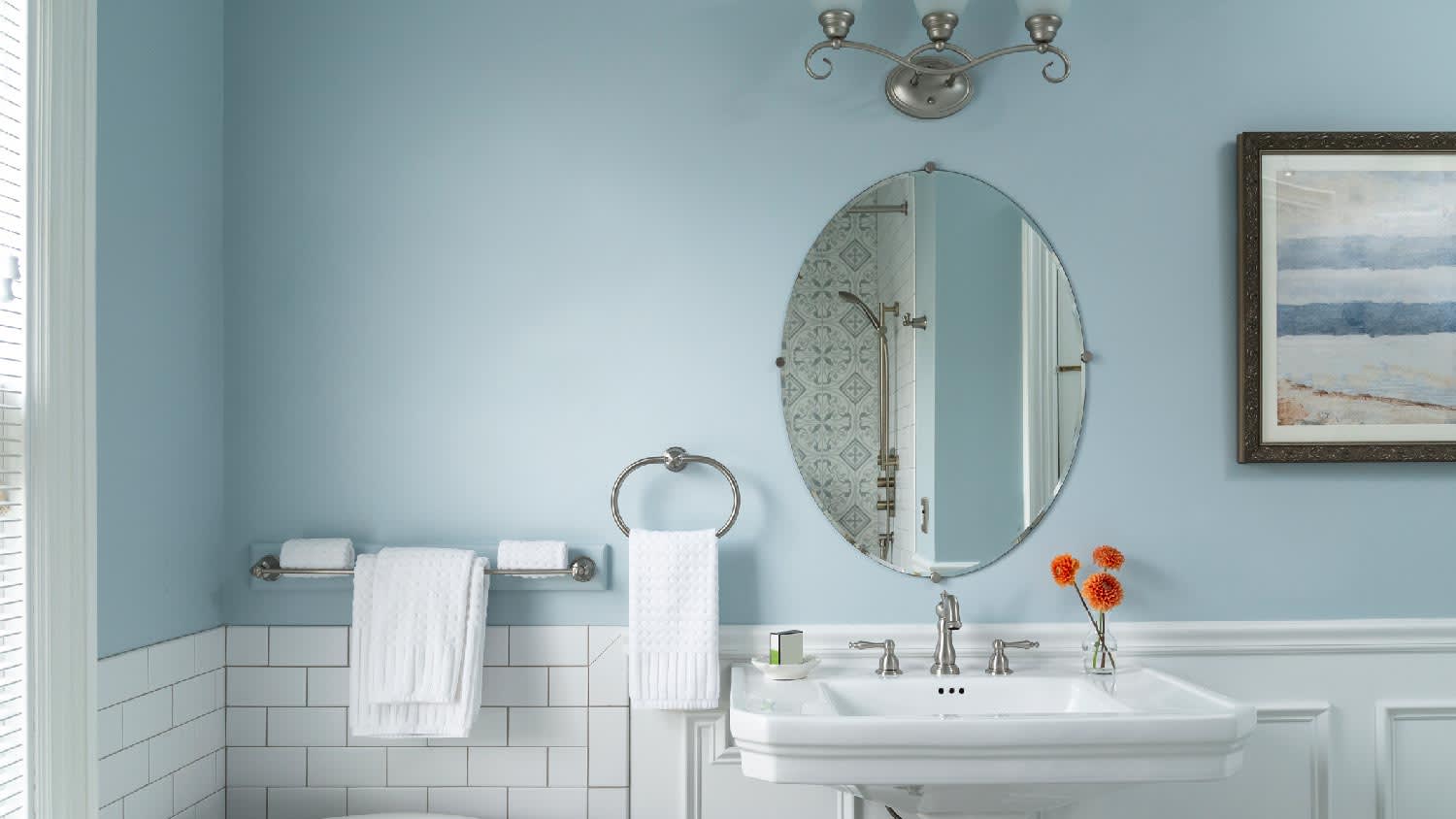 A bathroom painted in a baby blue hue