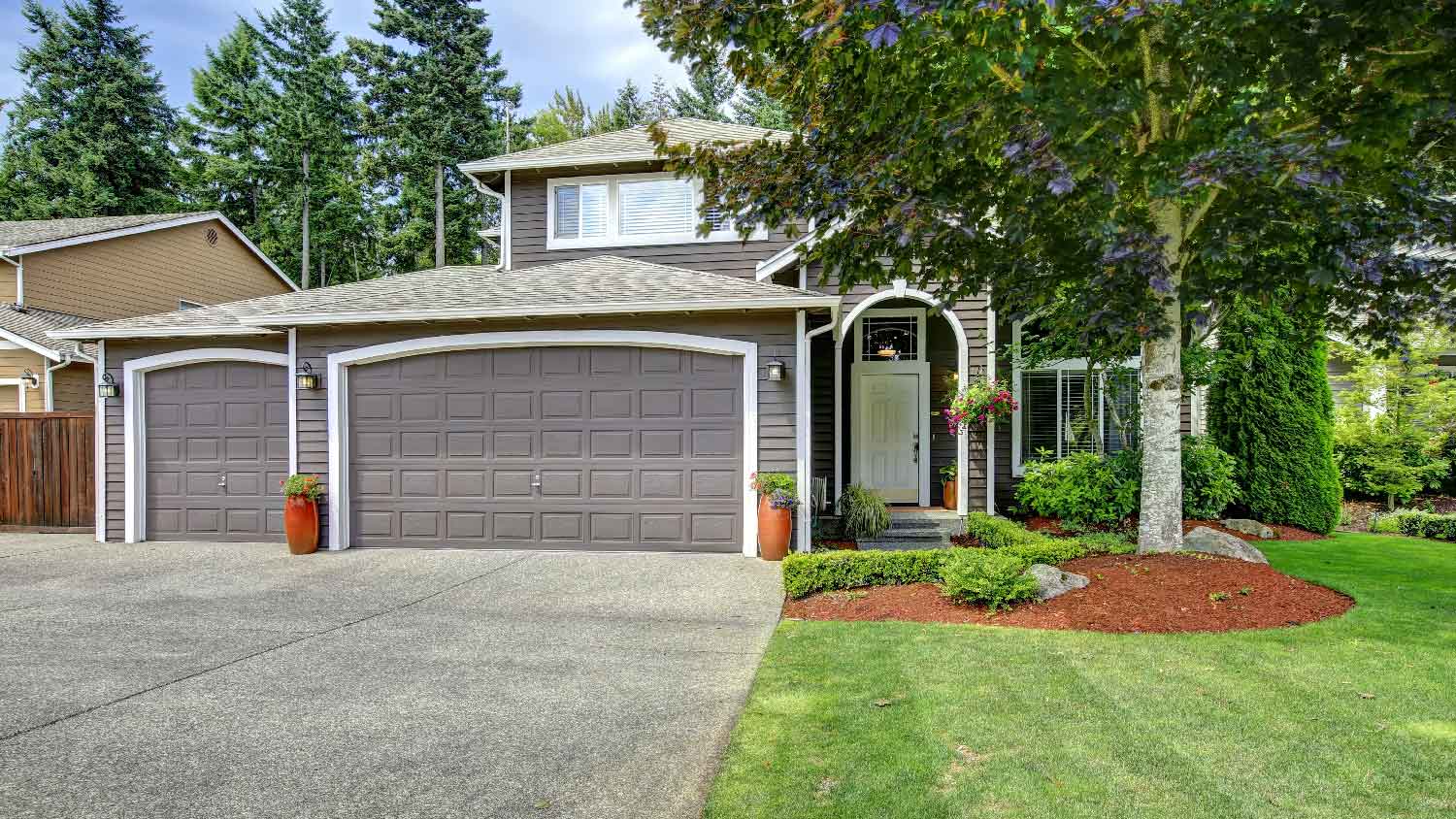 A driveway made of decomposed granite leading to a garage