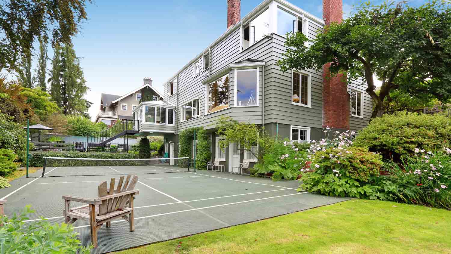 luxury home with outdoor tennis court