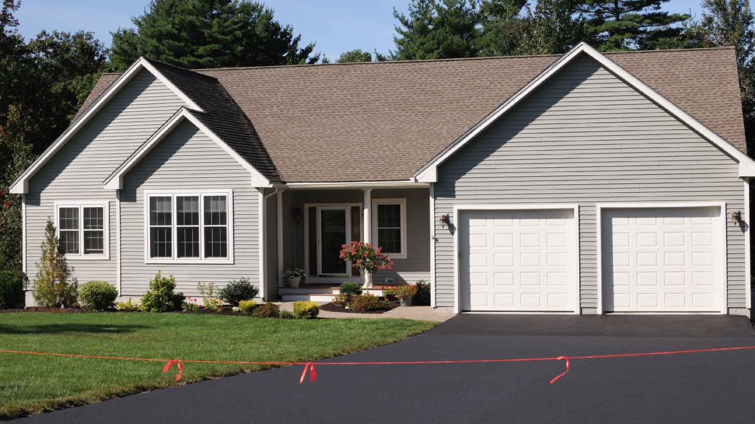 A house with a newly layed asphalt driveway